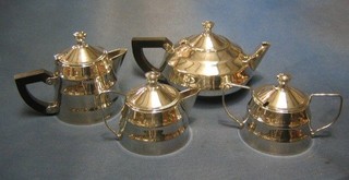 An Art Deco 4 piece silver plated tea service of circular form comprising teapot, twin handled sugar bowl and cover, hotwater jug and cream jug, the base marked PCS
