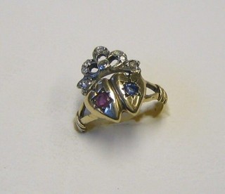 A gold friendship ring in the form of 2 hearts set a sapphire and ruby, surmounted by a diamond