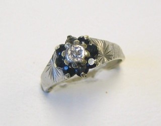 A modern 9ct white gold dress ring set sapphires and diamonds (1 sapphire missing)