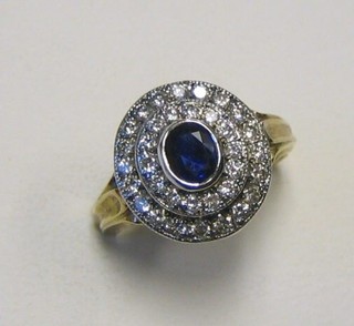 A lady's 18ct yellow gold dress ring set an oval cut sapphire supported by 2 rows of numerous diamonds