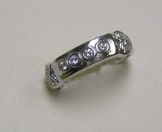 A lady's 18ct white gold dress ring set 4 diamonds and having hearts cast to the shoulders set numerous diamonds