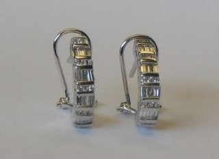 A pair of modern 18ct white gold earrings set numerous baguette cut diamonds