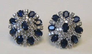 A particularly impressive pair of lady's white gold ear studs set 9 oval cut sapphires and numerous diamonds