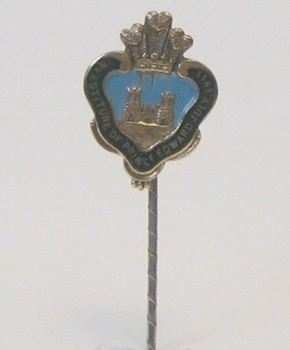 A gilt metal and enamelled stick pin to commemorate the Investiture of Prince Edward Prince of Wales July 1911