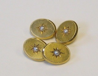 A pair of 18ct gold oval cufflinks set demi-pearls