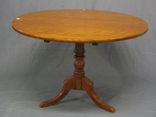A 19th Century circular tea table, raised on a bulbous turned column 35" 