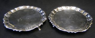 A matched pair of George III silver waiters/salvers with bracketed borders, raised on 3 hoof supports, makers mark RH,  London 1780 and 1783 6 1/2", 14 ozs (to be sold as a pair on the instructions of the vendor)