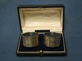 A pair of engraved silver napkin rings, Sheffield 1918, cased