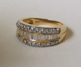 A lady's 18ct yellow gold dress ring set numerous baguette cut diamonds supported by diamonds