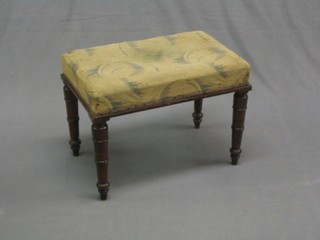 A 19th Century rectangular mahogany stool, raised on ring turned supports 22"