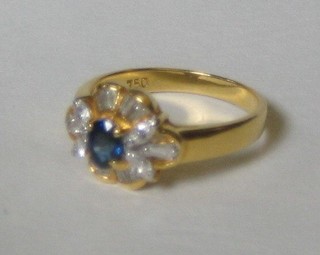A lady's 18ct gold dress ring set an oval cut sapphire supported by 10 baguette cut diamonds and 4 circular cut diamonds