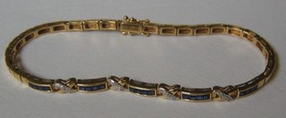 A lady's 18ct gold bracelet set 5 panels of 4 square cut sapphires interspaced by a diagonal of diamonds