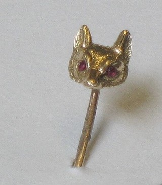 A gold stick pin in the form of a foxes mask, the eyes set rubies