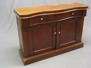 A Victorian mahogany chiffonier of serpentine outline, fitted 1 long drawer above a double cupboard, raised on a platform base, 47" (back missing)
