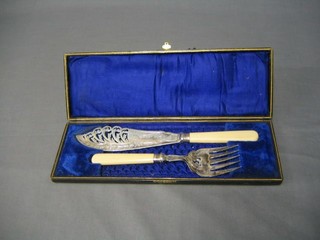 A pair of pierced silver plated fish servers, cased