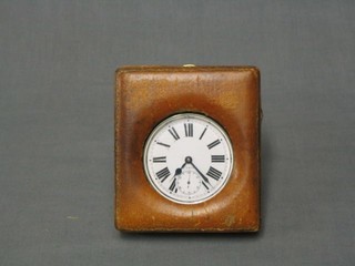 An 8 day travelling watch with enamelled dial and Roman numerals contained in a leather carrying case