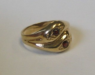 A 9ct gold dress ring in the form of 2 entwined serpents, the eyes set red stones
