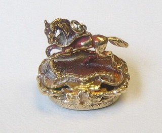 A gold seal in the form of a running horse, the base set an intaglio cut green stone