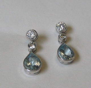 A pair of lady's aquamarine tear drop earrings surmounted by 2 diamonds (approx 0.62ct/2.12ct)