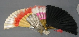 A pierced ivory fan, a mother of pearl and ostrich feather fan and 3 other fans