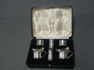 An Art Deco 6 piece silver condiment set comprising pair of mustard pots, pair of salts, pair of peppers and 4 salt spoons with Jubilee mark 1935, cased, purchased at Harrods