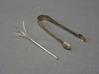 A pair of George III silver bright cut sugar tongs London 1801 and a silver swizzle stick