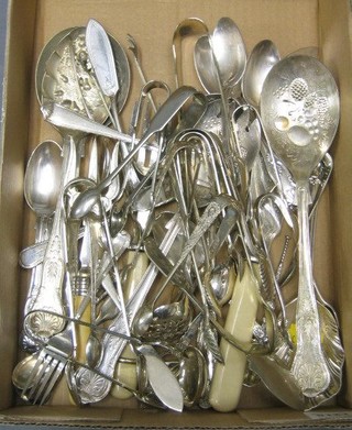 A pair of silver plated fish servers, various silver plated sugar tongs and plated flatware