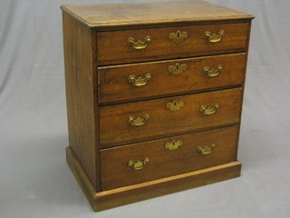 A Georgian Country oak chest of 4 graduated drawers with brass swan neck plate drop handles, raised on a platform base 31"