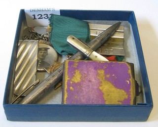 A Continental silver and gilt metal bracelet hung various enamelled charms and a gilt metal double photograph locket, 2 safe driving campaign medals, a silver propelling pencil, silver money clip, small pen knife and a match slip
