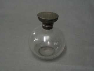 A cut glass globular shaped scent bottle with engine turned silver lid