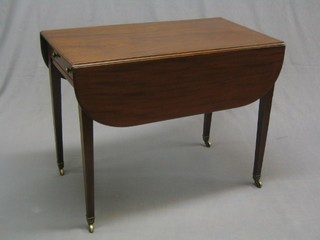 A  Georgian mahogany Pembroke table fitted a drawer and raised on square tapering supports ending in brass caps and castors 36"