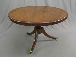 A 19th Century circular snap top breakfast table, raised on bulbous turned and tripod supports ending in brass caps and castors 48"