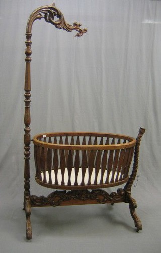 A handsome carved William IV mahogany oval cradle and stand