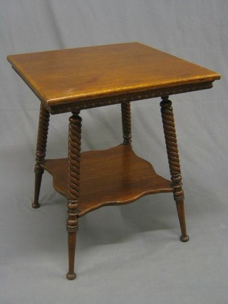 An Edwardian honey oak square 2 tier occasional table raised on spiral turned supports with undertier 24"