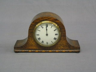A Swiss 1930's 8 day bedroom timepiece with porcelain dial and Roman numerals contained in an oak arched case