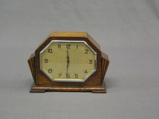 A 1930's Art Deco 8 day bedroom timepiece with lozenge silvered dial and Arabic numerals contained in an oak case