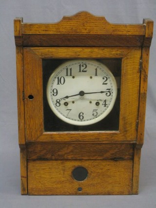 The top section of an American Simplex time recorder, the 8" painted dial with Roman numerals contained in a honey oak case (bottom section missing)