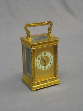 A fine quality French 19th Century carriage clock with porcelain dial and Arabic numerals contained in a gilt metal case (glass to side panel damaged)