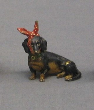 An Austrian cold painted bronze figure of a seated Dachshund with bandaged head 2"