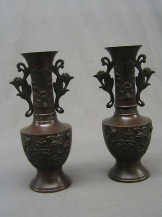 A pair of 19th Century Eastern twin handled bronze urns, the bodies cast birds amidst branches 14" (1 handle f)