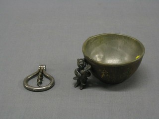 A circular carved coconut bowl with zinc liner 3 1/2", an Eastern  bronze figure of an attendant with fan 2", a polished steel corkscrew  and a bronze plaque in the form of a lion 3"