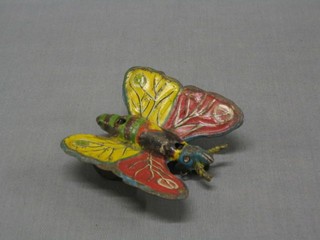 A tin plate clockwork figure of a butterfly 3"