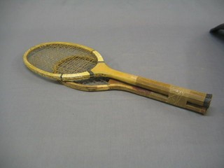 A childs tennis racquet and a wooden tennis racquet