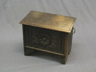 A Victorian carved oak coal box  of plank construction, with hinged lid, zinc liner and brass drop handles, raised on bracket feet 20"
