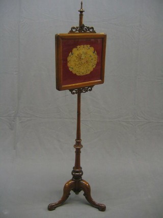 A Victorian mahogany pole screen with Berlin wool work banner, raised on tripod supports
