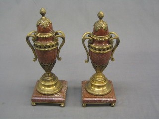 A handsome pair of 20th Century granite and gilt metal mounted urns and covers, raised on square bases 13"