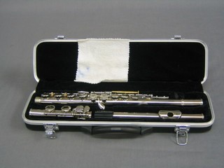 A silver plated 3 piece flute by Sky, complete with carrying case
