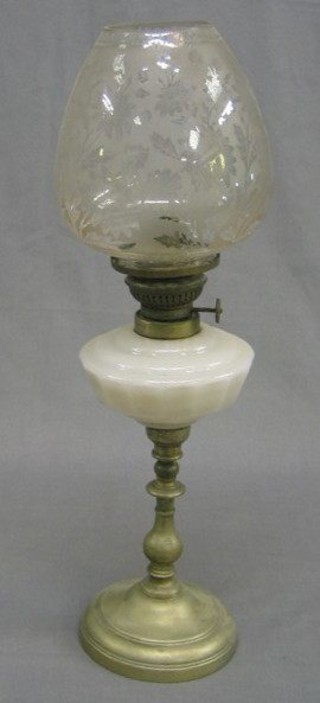A white glass oil lamp with etched glass shade and polished steel body