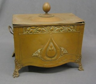 An Art Nouveau embossed brass twin handled coal bin with hinged lid 17"