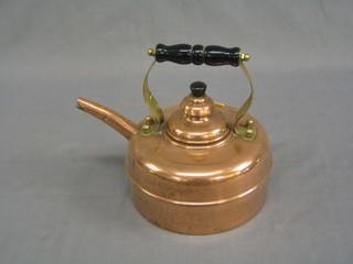 A copper kettle with turned ebony handle